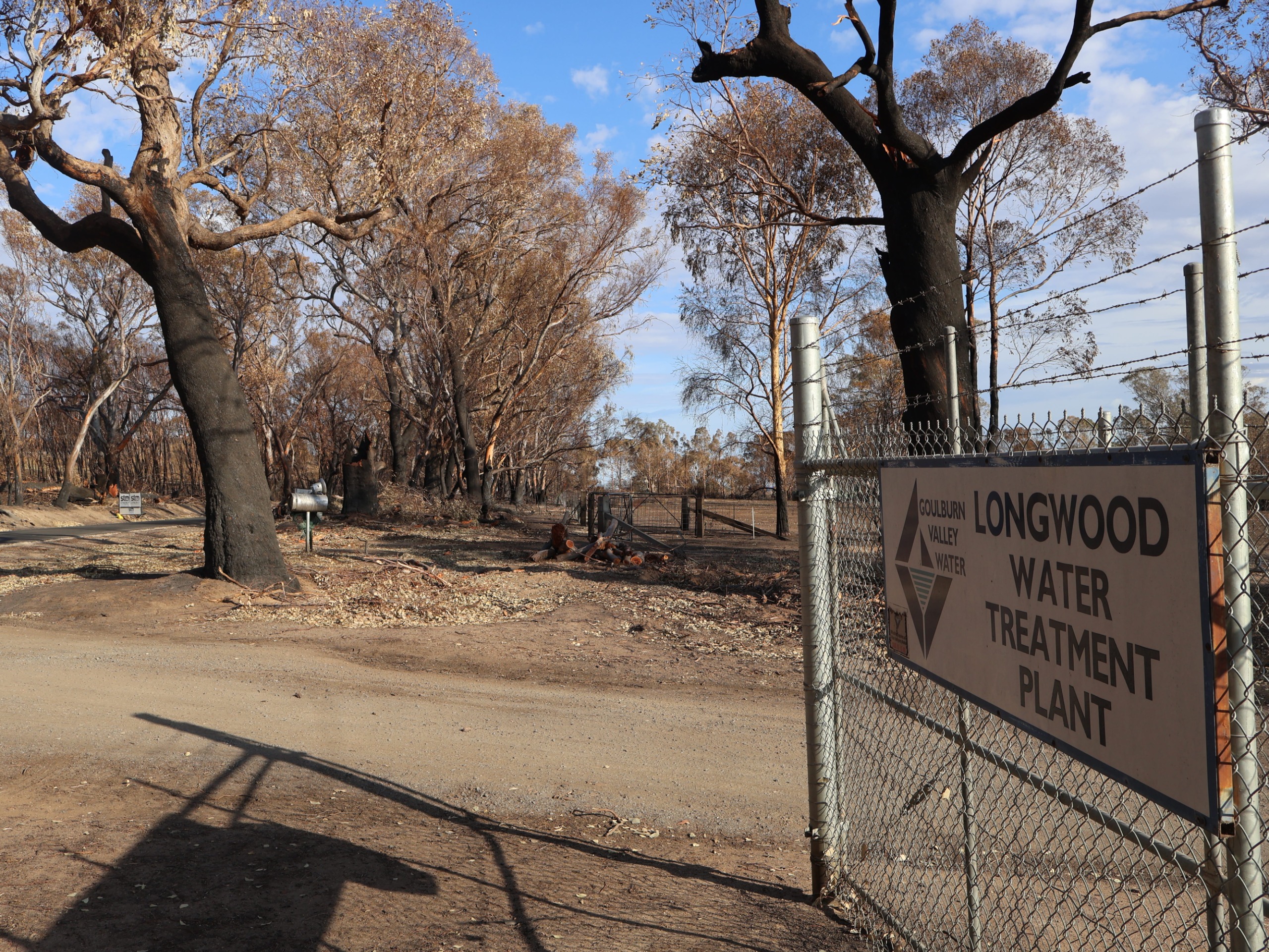 Longwood Water Treatment Plant entry sign surrounded by burnt ground, after the bushfire had gone through.